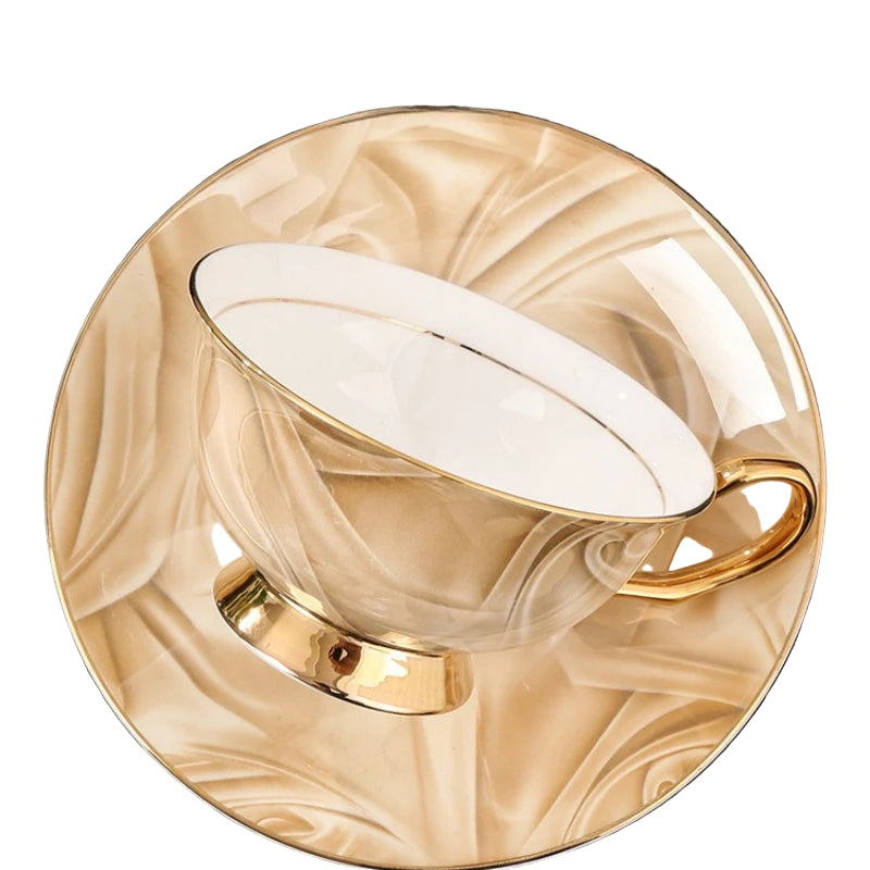 Gold and white coffee cup on a saucer