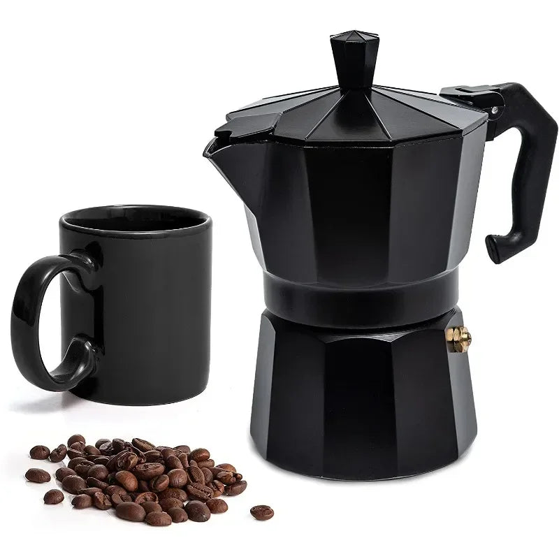Black stovetop espresso maker with a black mug and coffee beans on a white background