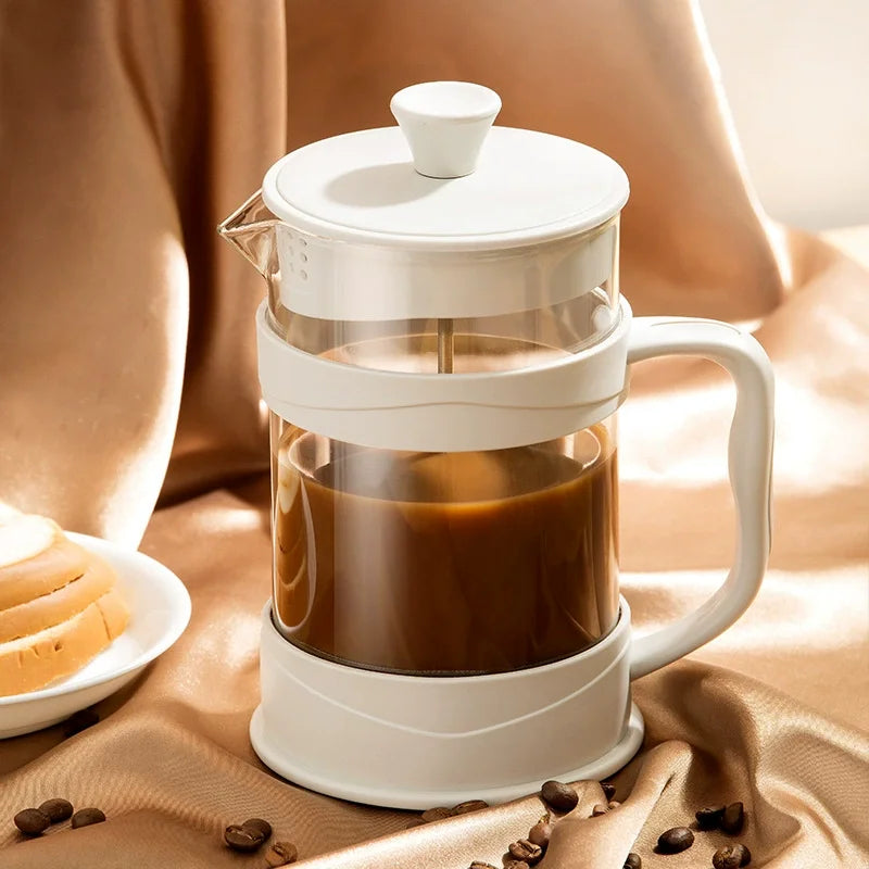 French press filled with coffee on a beige fabric background