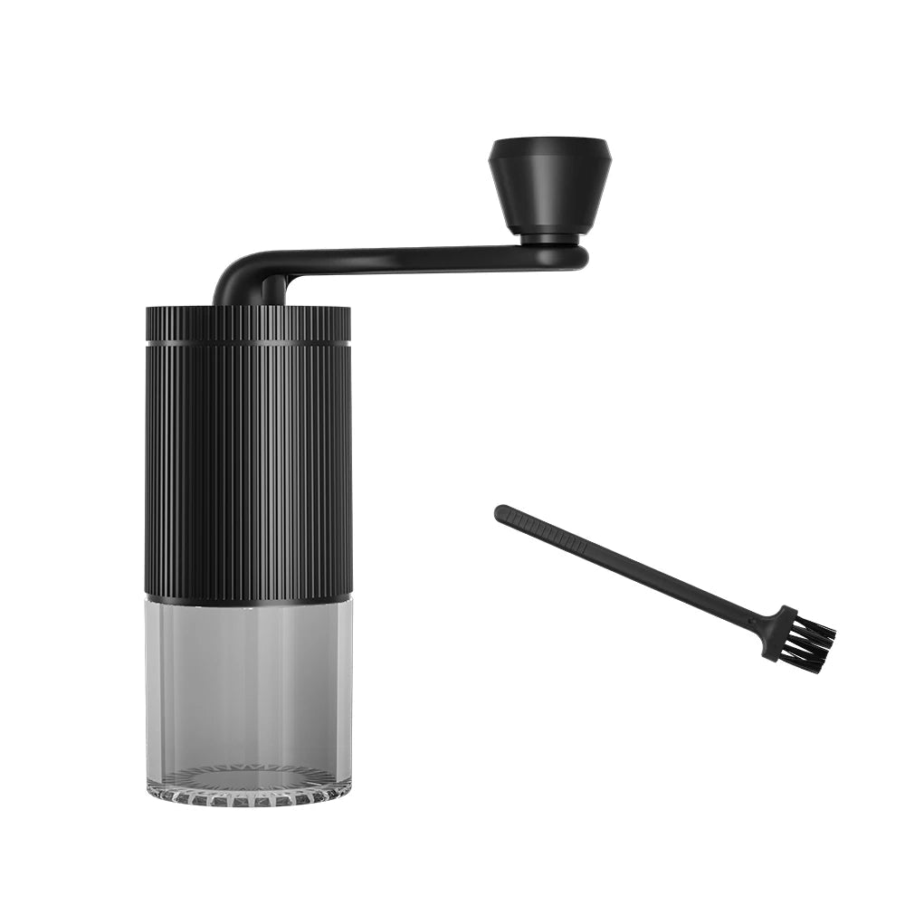 Black coffee grinder with cleaning brush on a white background