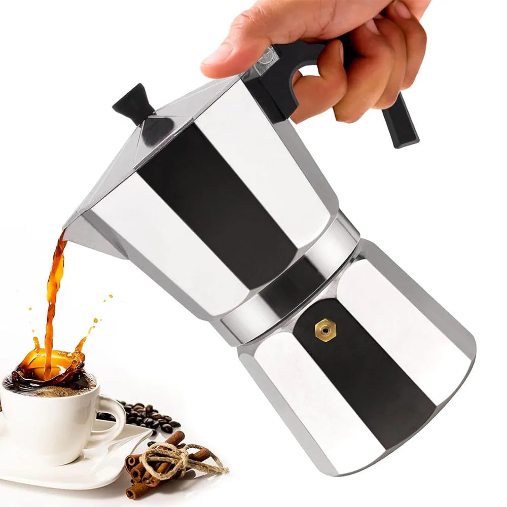 Silver French press being used to pour coffee into a cup on a white background
