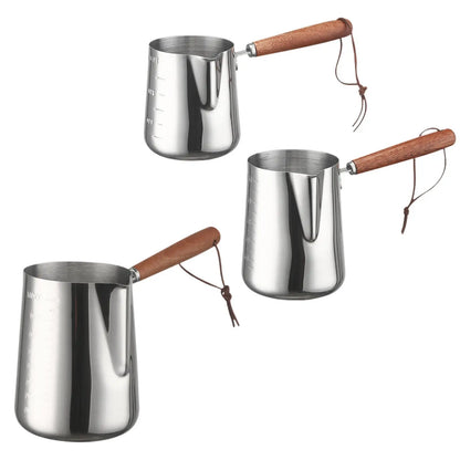 Three stainless steel Turkish coffee makers with wooden handles on a white background