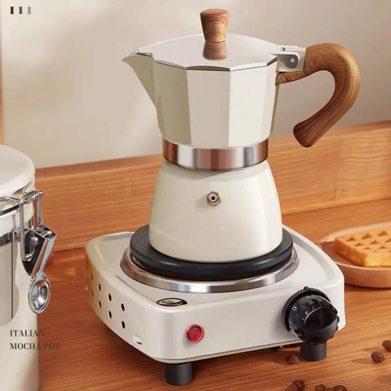 White Moka pot with wooden handles on a hot plate on a wooden surface.